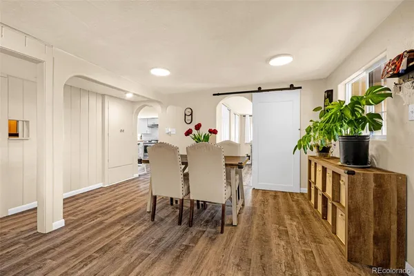 a view of a dining room with furniture and wooden floor