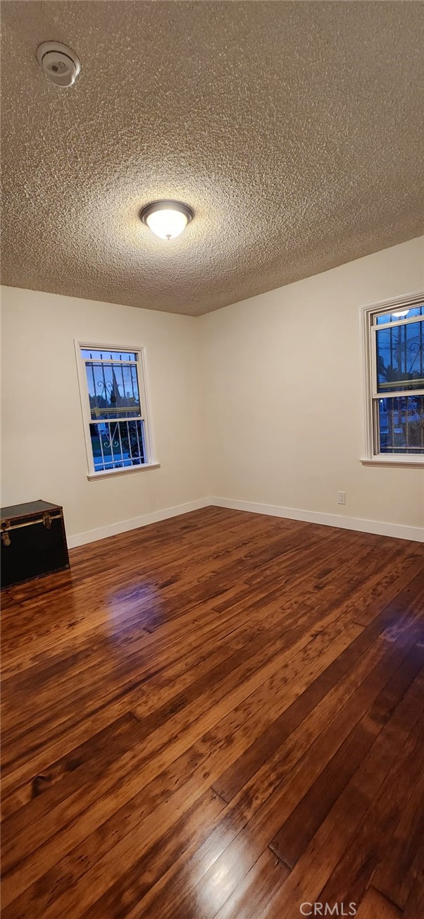 520 West Raymond Street Compton, CA 90220 - Photo 11 of 31 an empty room with wooden floor