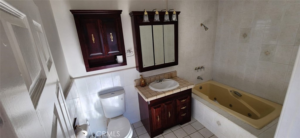 520 West Raymond Street Compton, CA 90220 - Photo 21 of 31 a bathroom with a sink and mirror with bathtub