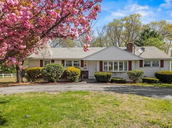 a front view of a house with swimming pool and porch