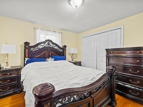 a bedroom with a bed and dresser