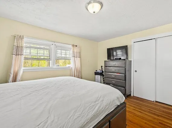 a bedroom with a bed and a dresser