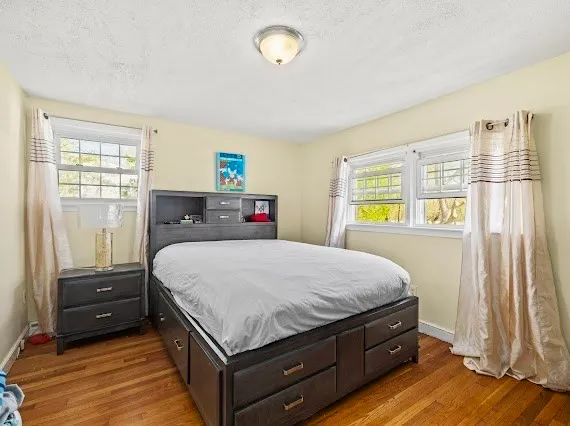 a bed sitting in a bedroom next to a window