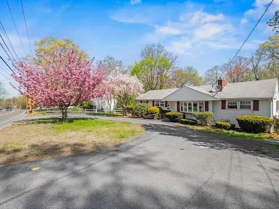 a view of house with yard and entertaining space