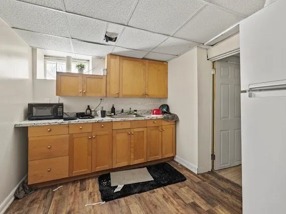 a kitchen with granite countertop cabinets and window