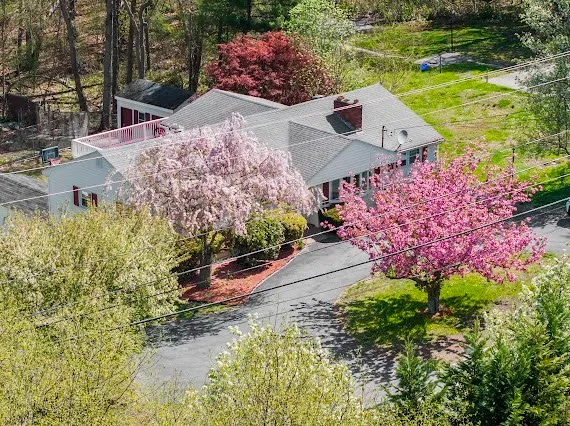 an aerial view of a house with a yard
