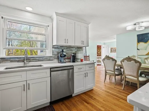 a kitchen with sink cabinets and wooden floor