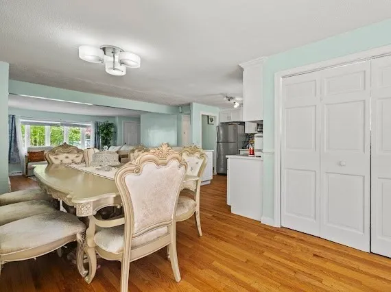 a view of a dining room with furniture and wooden floor