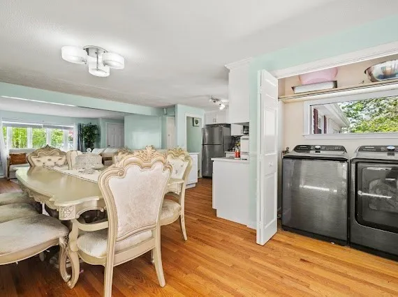 a view of a dining room with furniture a kitchen and chandelier