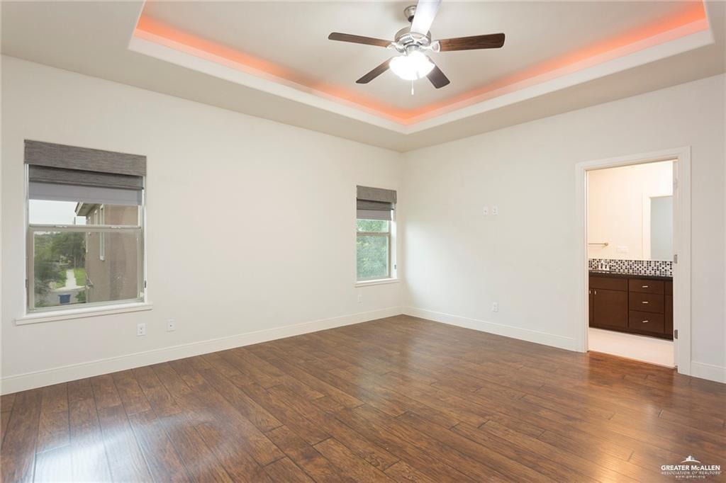 3016 South L Street, Unit 2 McAllen, TX 78503 - Photo 5 of 10 a view of an empty room with a window and wooden floor