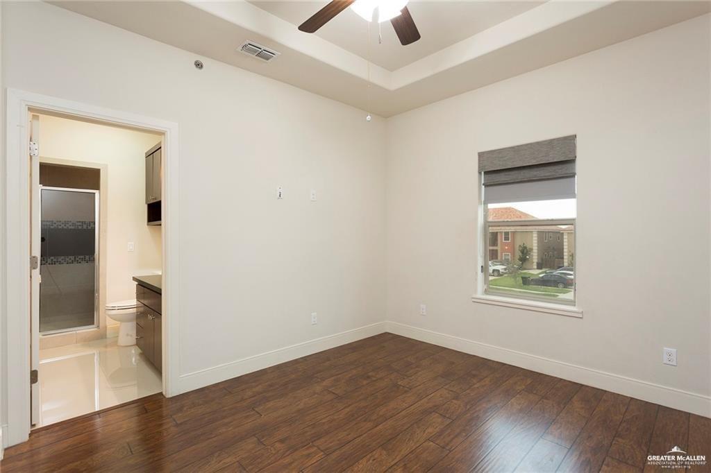 3016 South L Street, Unit 2 McAllen, TX 78503 - Photo 7 of 10 an empty room with wooden floor and windows