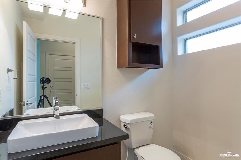 3016 South L Street, Unit 2 McAllen, TX 78503 - Photo 8 of 10 a bathroom with a sink and a mirror