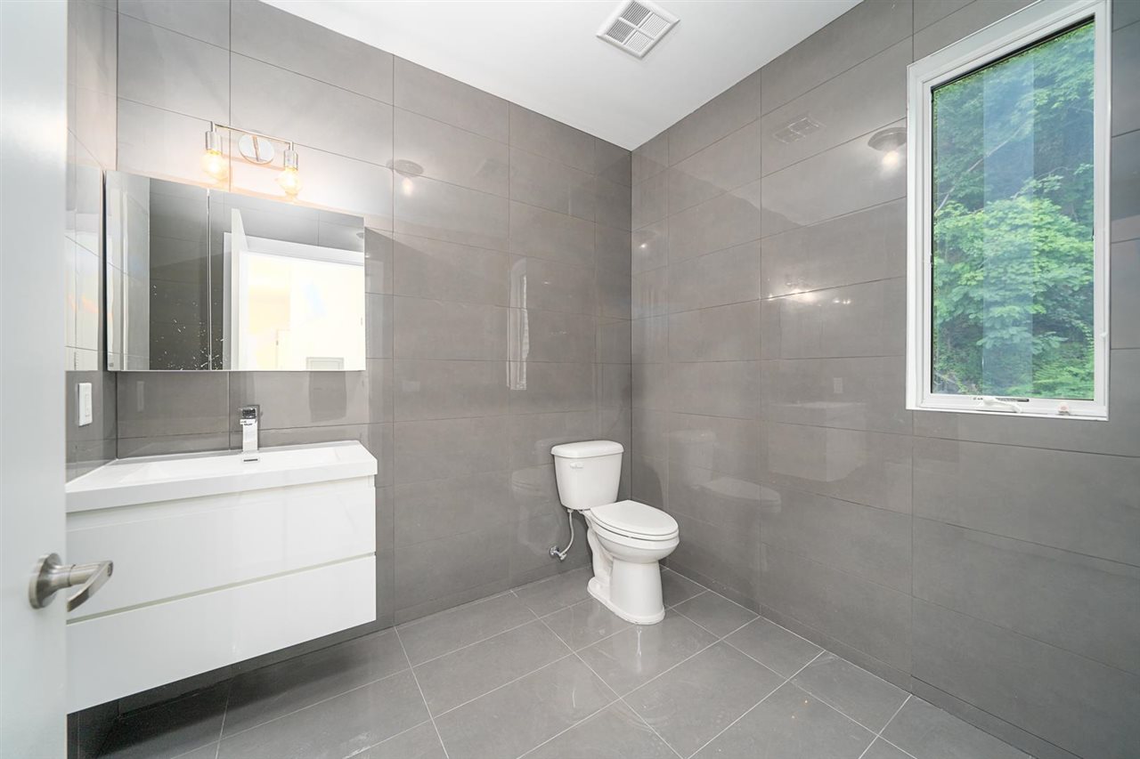 8621 River Road, Unit 6D North Bergen, NJ 07047 - Photo 20 of 34 a bathroom with a sink toilet and a mirror
