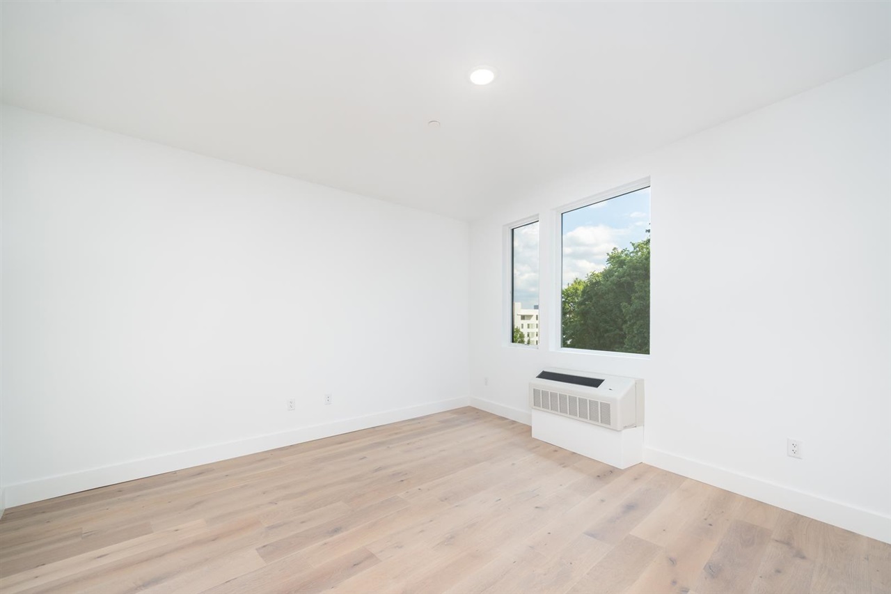 8621 River Road, Unit 6D North Bergen, NJ 07047 - Photo 5 of 34 an empty room with wooden floor and windows