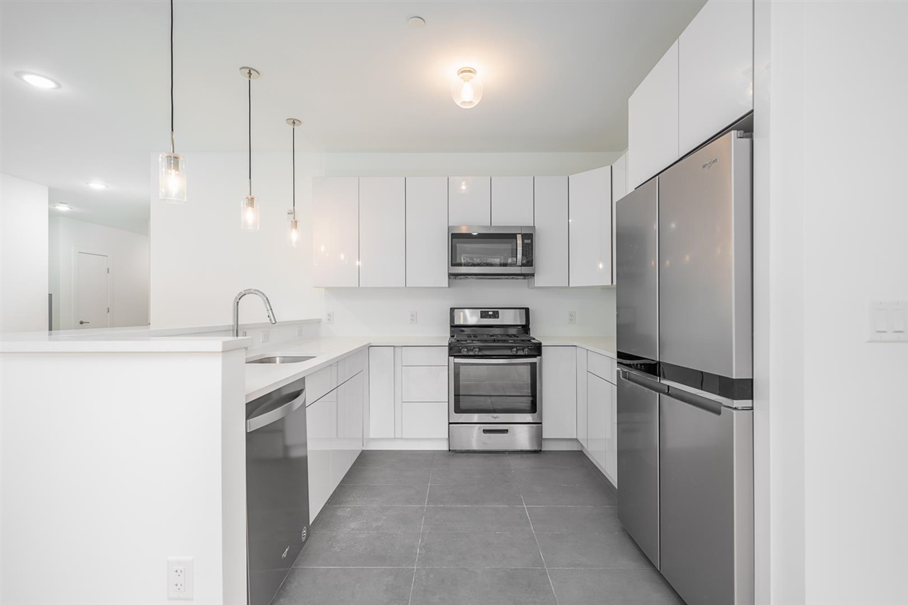 8621 River Road, Unit 6D North Bergen, NJ 07047 - Photo 8 of 34 a kitchen with kitchen island a sink appliances and cabinets