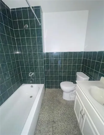 a bathroom with a bathtub and toilet