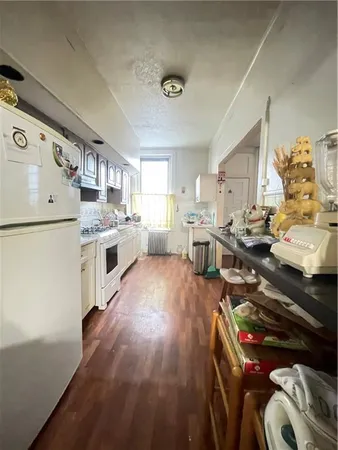 a kitchen with stainless steel appliances granite countertop a stove and a refrigerator