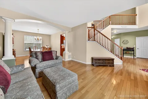 a view of a dining room with furniture wooden floor and chandelier