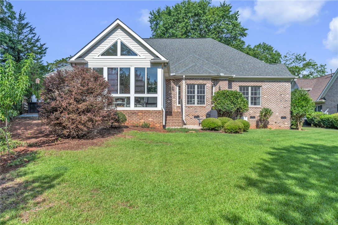 102 Country Walk Lane Clemson, SC 29631 - Photo 2 of 39 A classic brick exterior blends seamlessly with the verdant lawn and mature landscaping.