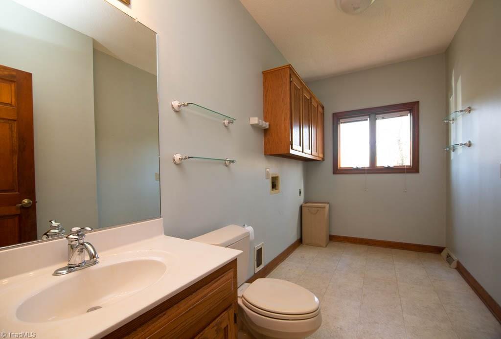 6520 Hollow River Drive Oak Ridge, NC 27310 - Photo 14 of 26 Large laundry room and half bath off the garage and kitchen.