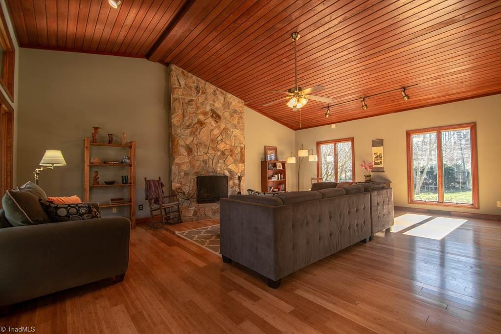 6520 Hollow River Drive Oak Ridge, NC 27310 - Photo 7 of 26 Great room with beautiful stone, wood-burning fireplace and wood barrel vaulted ceiling.