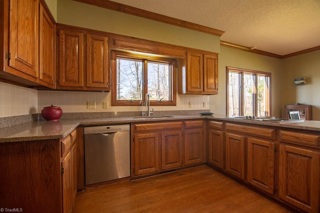 6520 Hollow River Drive Oak Ridge, NC 27310 - Photo 10 of 26 Wonderful kitchen with granite tops, downdraft cook-top, Bosch dishwasher, stainless refrigerator and walk-in pantry.