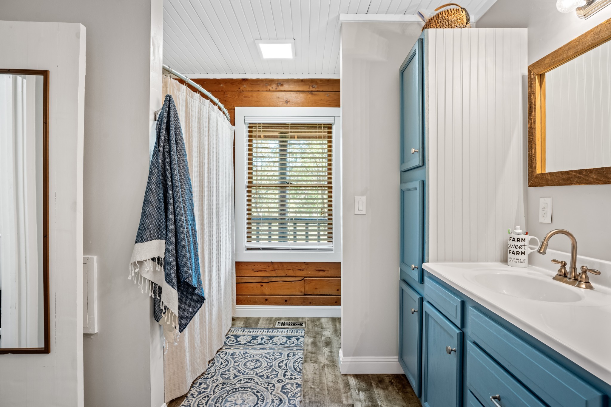 5285 Simmons Bluff Road Lebanon, TN 37090 - Photo 17 of 32 a bathroom with a sink a mirror and a window