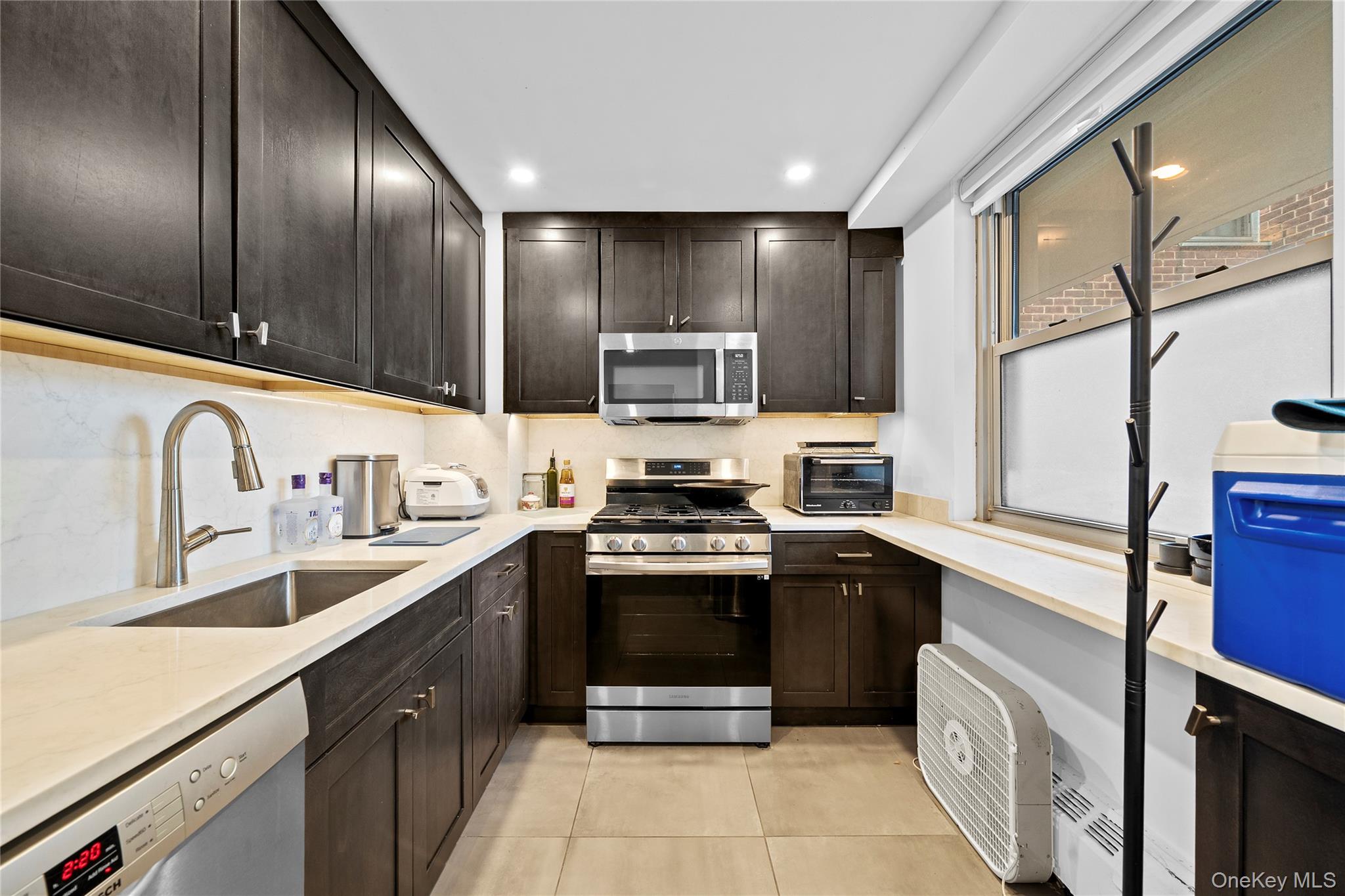 a kitchen with stainless steel appliances granite countertop a stove sink and cabinets