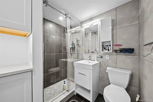 a bedroom with a bed a desk and chair with window