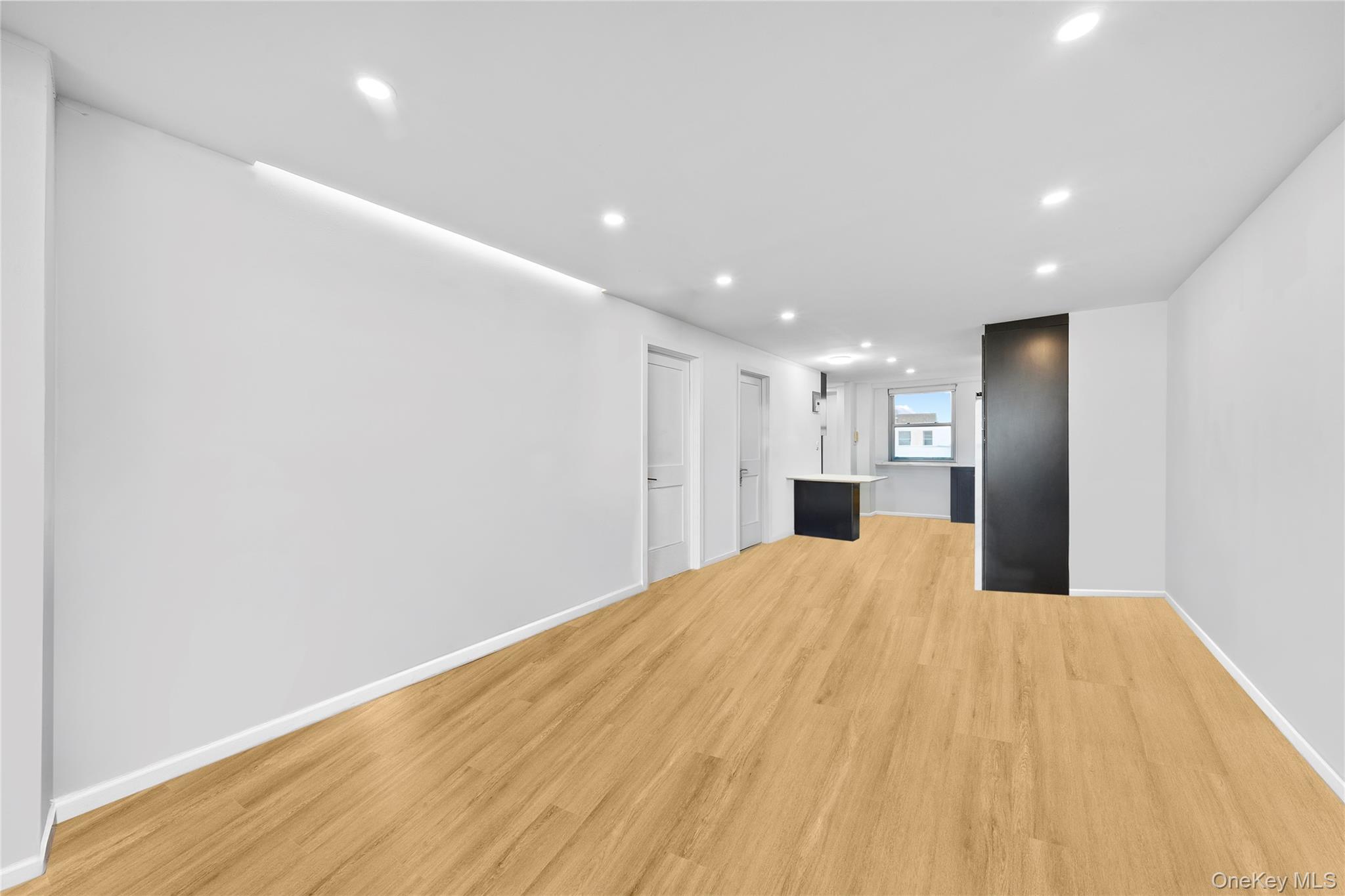 61-25 97th Street, Unit 12M Queens, NY 11374 - Photo 11 of 24 a view of an empty room with wooden floor