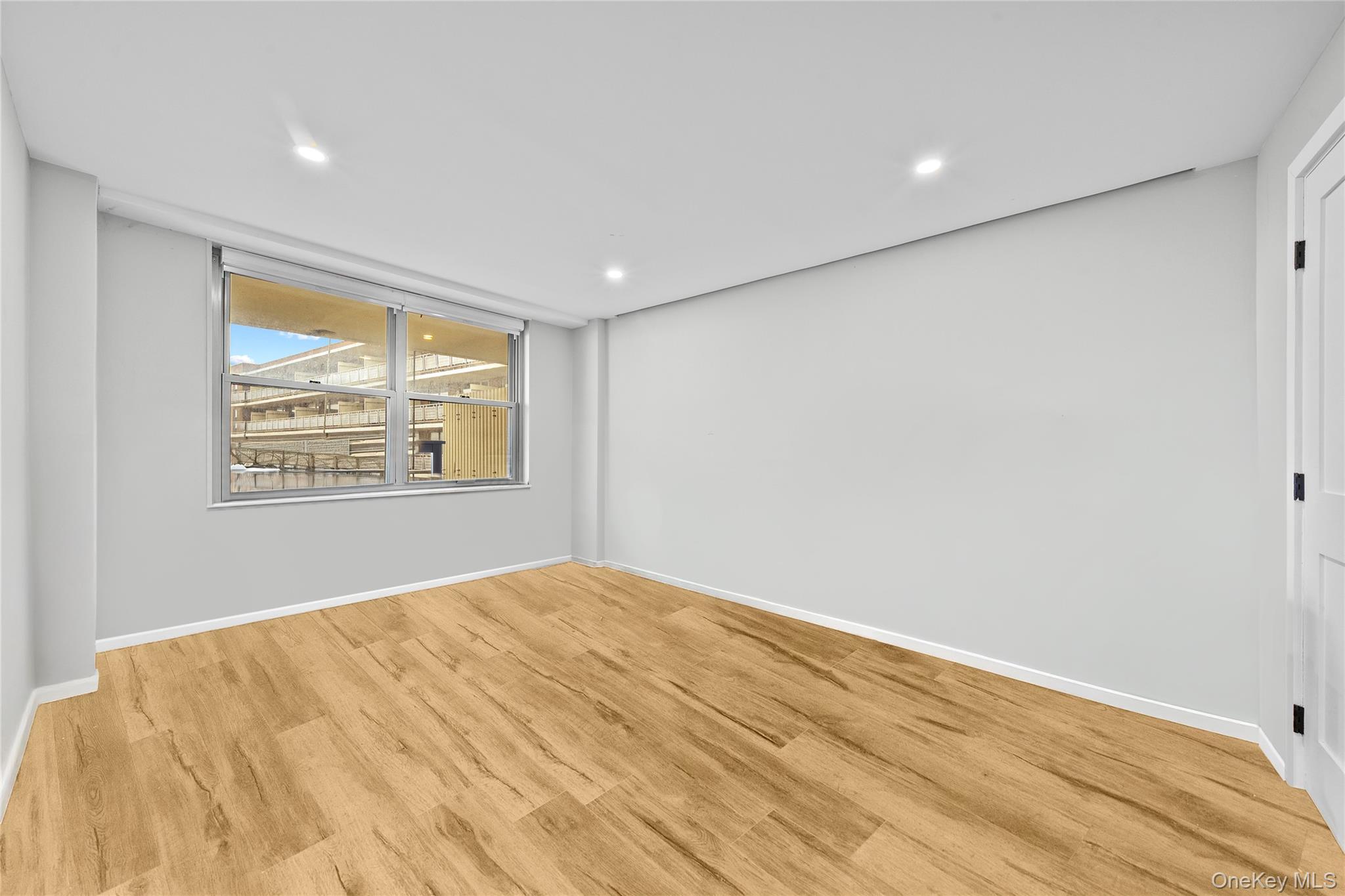 61-25 97th Street, Unit 12M Queens, NY 11374 - Photo 13 of 24 a big room with wooden floor and windows