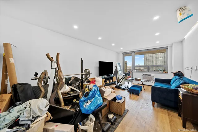 a big room with wooden floor and windows