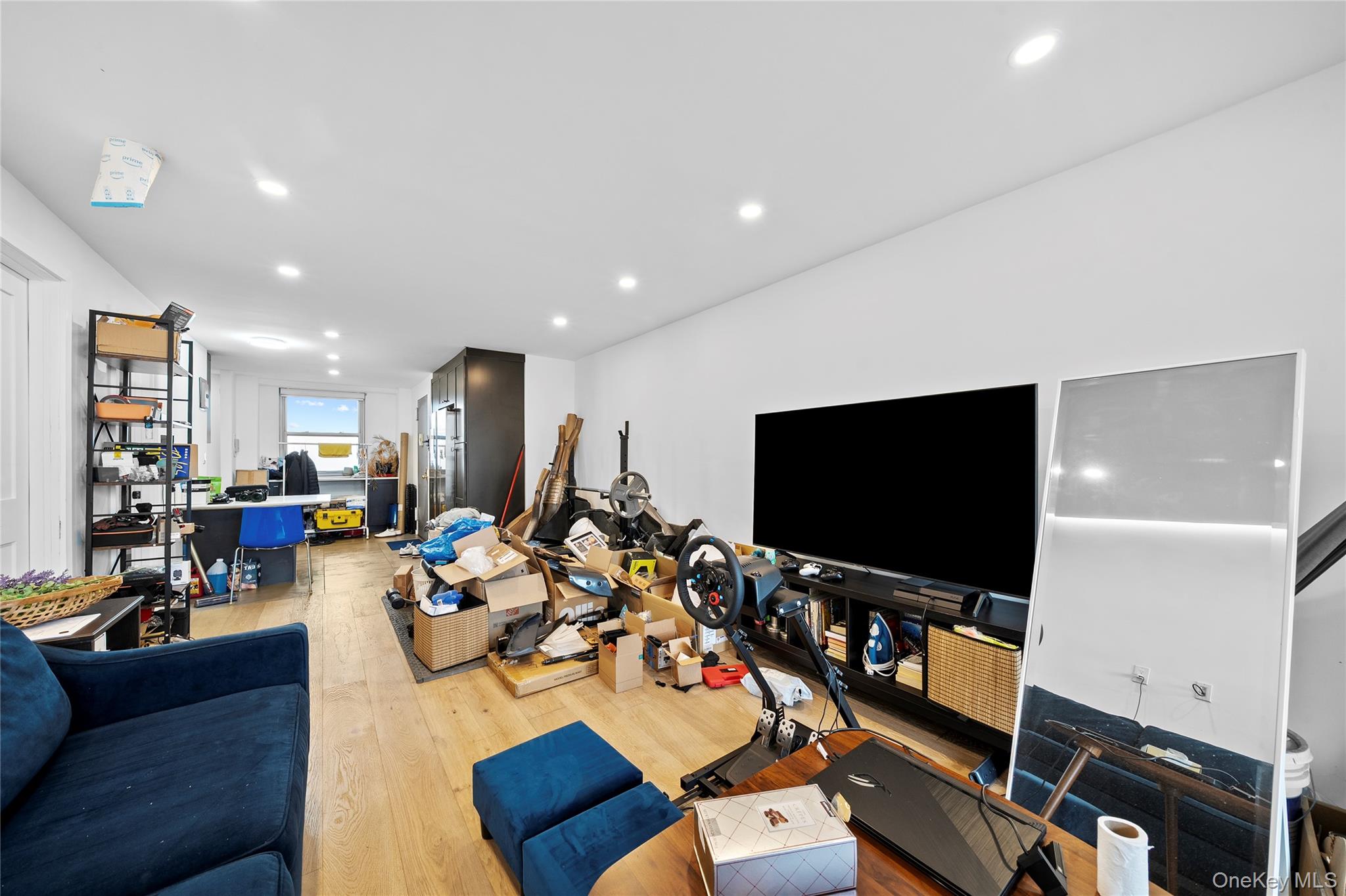 61-25 97th Street, Unit 12M Queens, NY 11374 - Photo 15 of 24 a living room with furniture and a flat screen tv