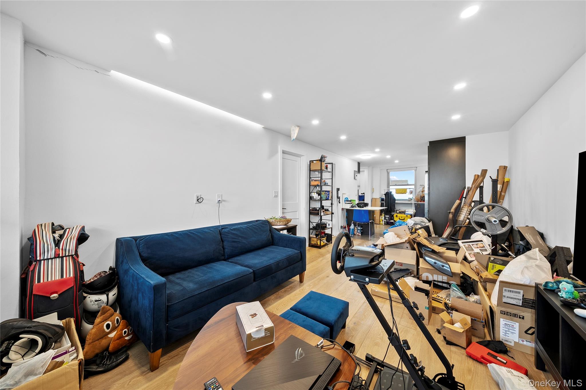 61-25 97th Street, Unit 12M Queens, NY 11374 - Photo 16 of 24 a living room with furniture and gym equipment