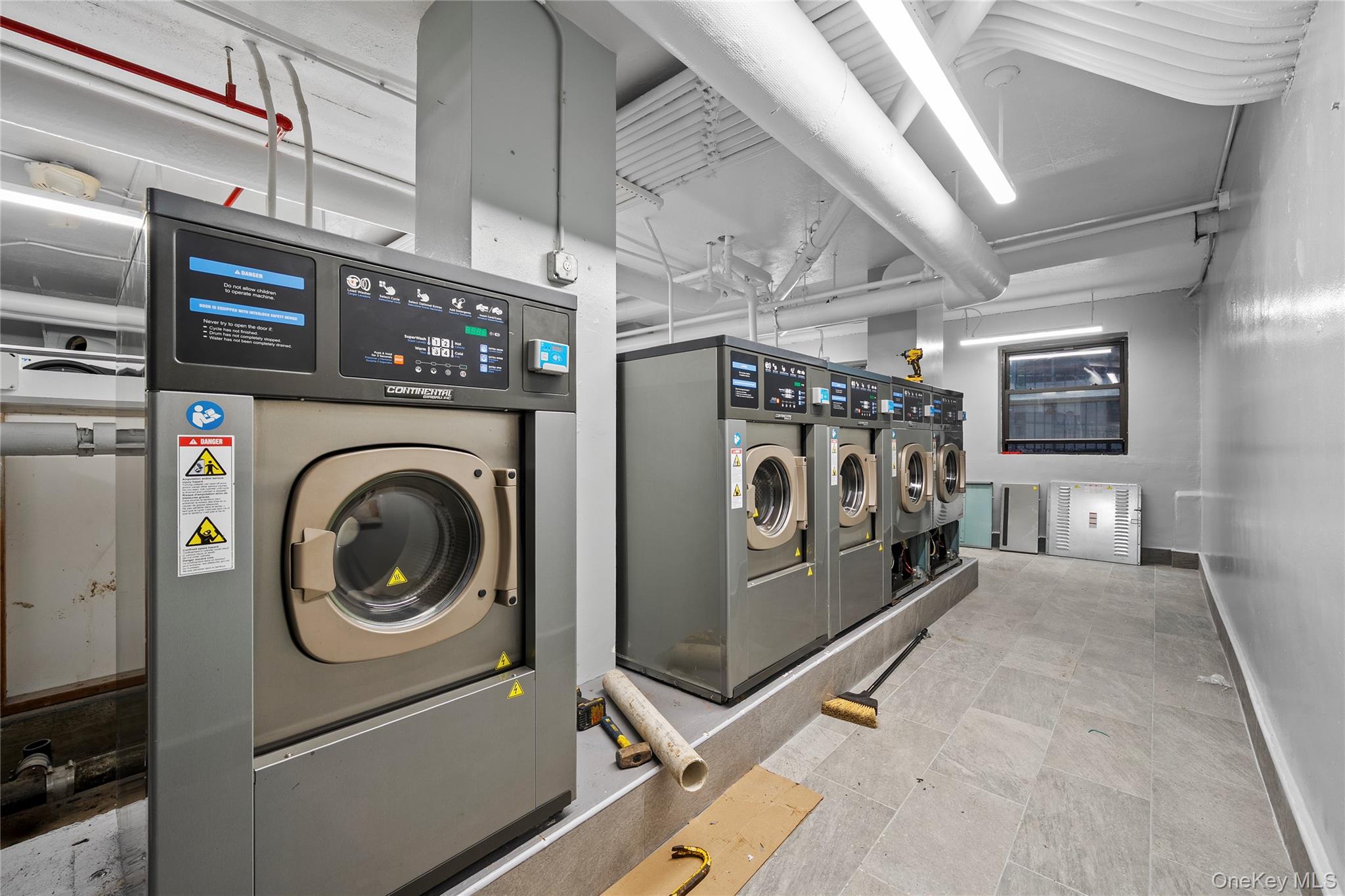 61-25 97th Street, Unit 12M Queens, NY 11374 - Photo 22 of 24 a view of a hallway with washer and dryer