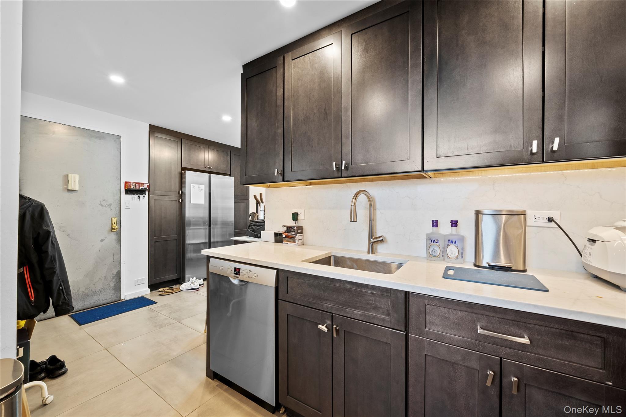61-25 97th Street, Unit 12M Queens, NY 11374 - Photo 7 of 24 a kitchen with stainless steel appliances granite countertop a sink stove and refrigerator