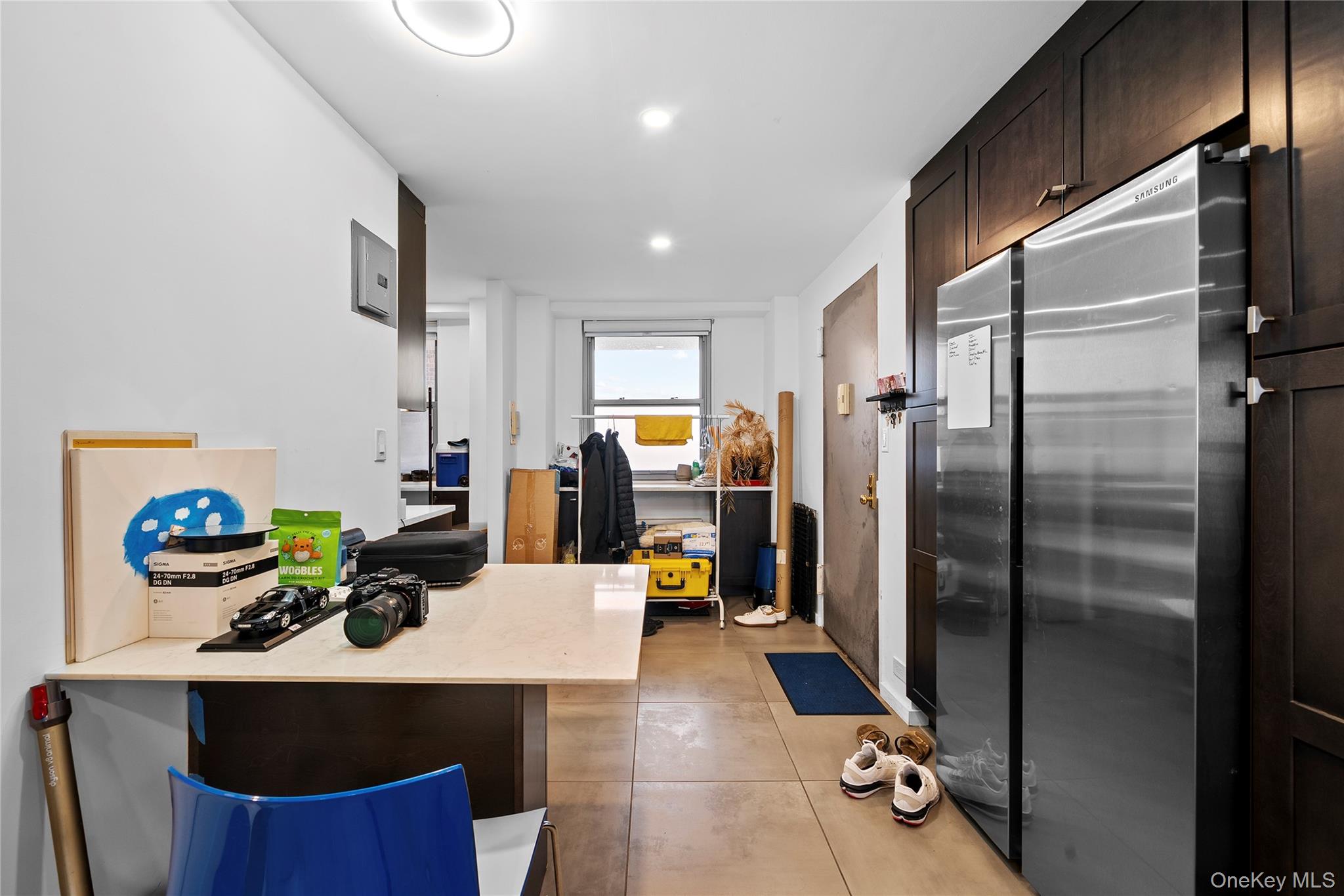 61-25 97th Street, Unit 12M Queens, NY 11374 - Photo 8 of 24 a view of a kitchen with fridge and workspace