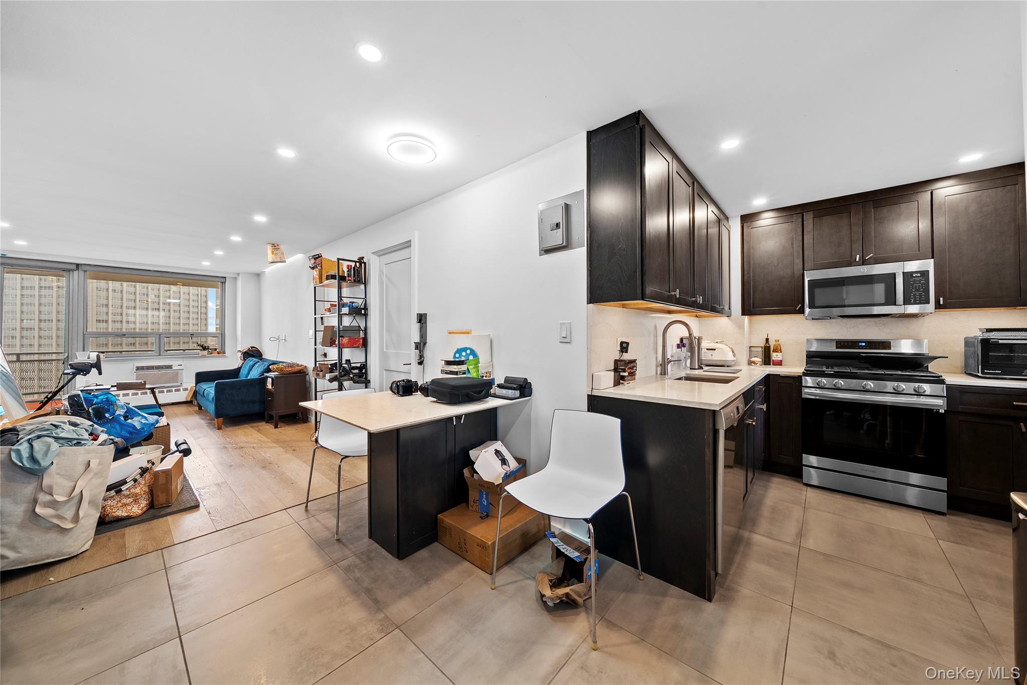 61-25 97th Street, Unit 12M Queens, NY 11374 - Photo 24 of 24 a large kitchen with a large counter top appliances and cabinets