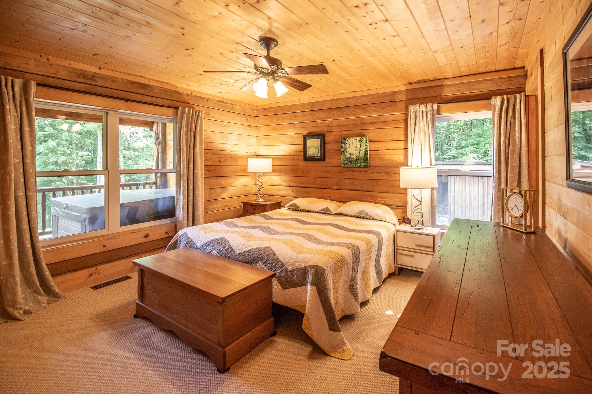 2811 Poplar Creek Road Green Mountain, NC 28740 - Photo 12 of 35 a spacious bedroom with a bed and wooden floor