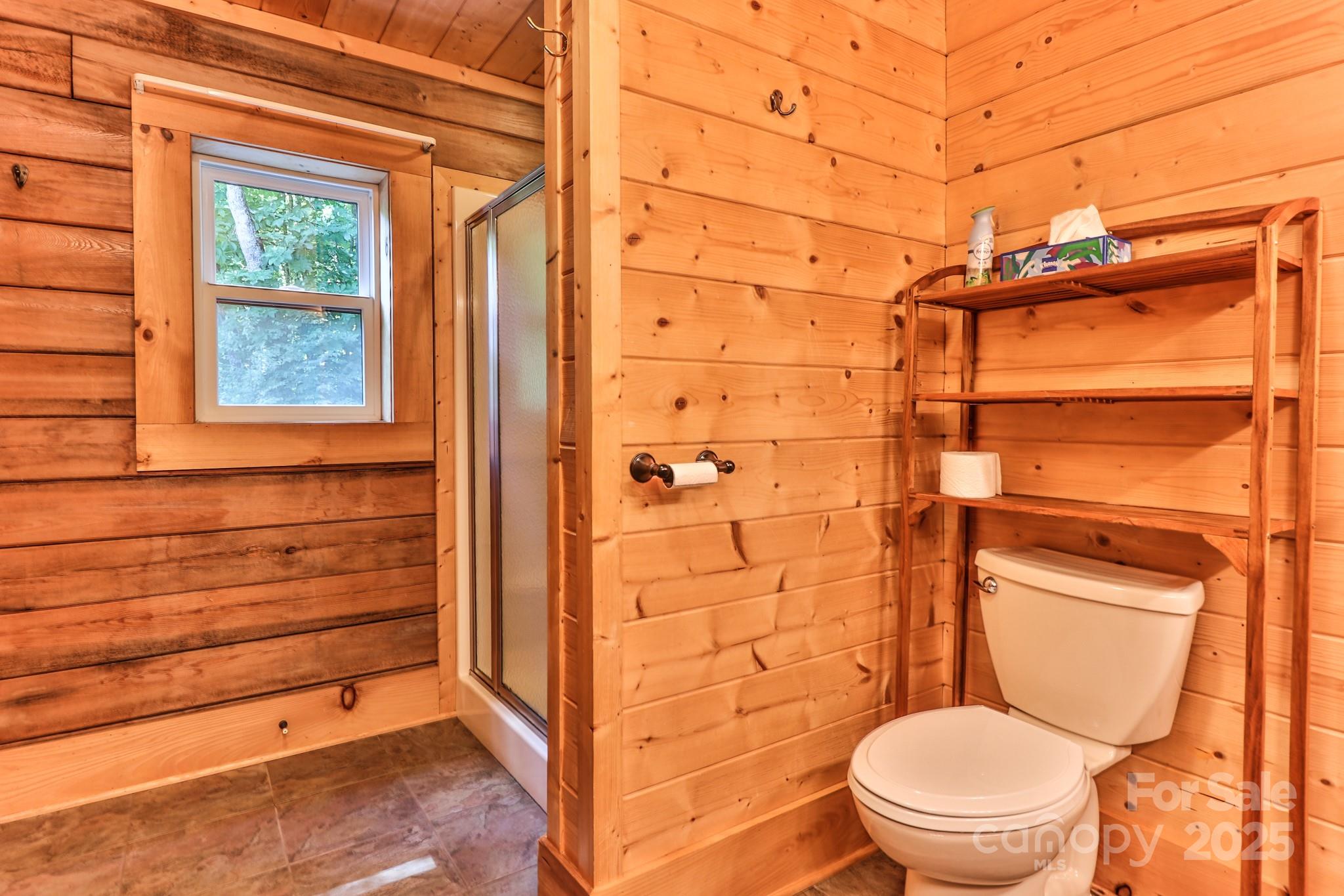 2811 Poplar Creek Road Green Mountain, NC 28740 - Photo 15 of 35 a bathroom with a toilet and a shower