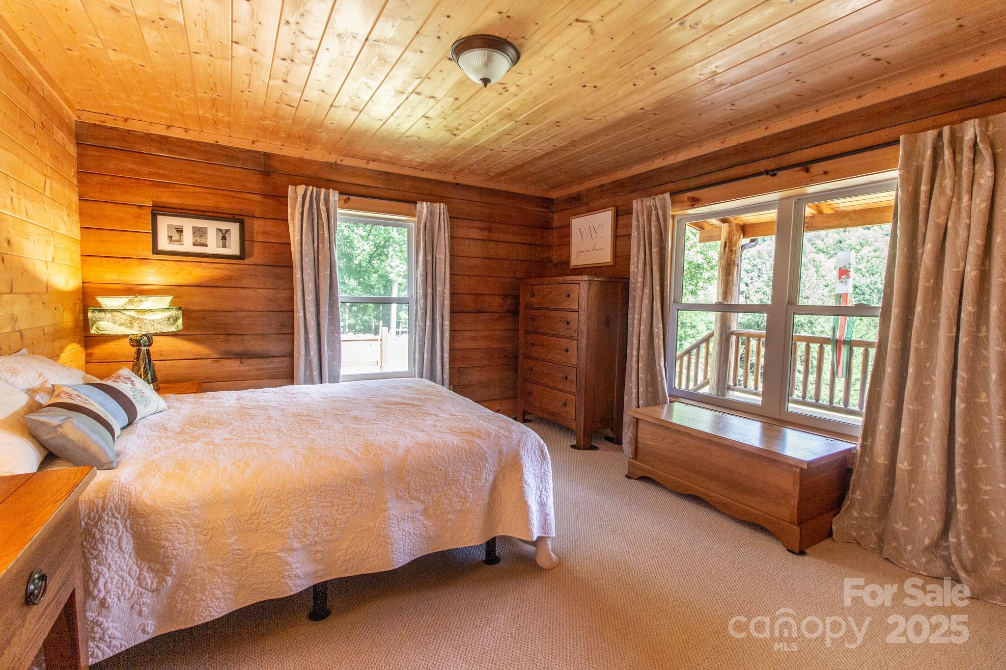 2811 Poplar Creek Road Green Mountain, NC 28740 - Photo 19 of 35 a spacious bedroom with a bed and a window