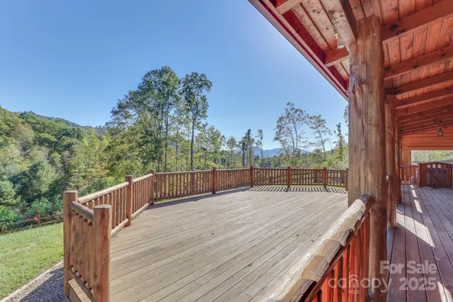 a view of balcony with wooden floor and fence