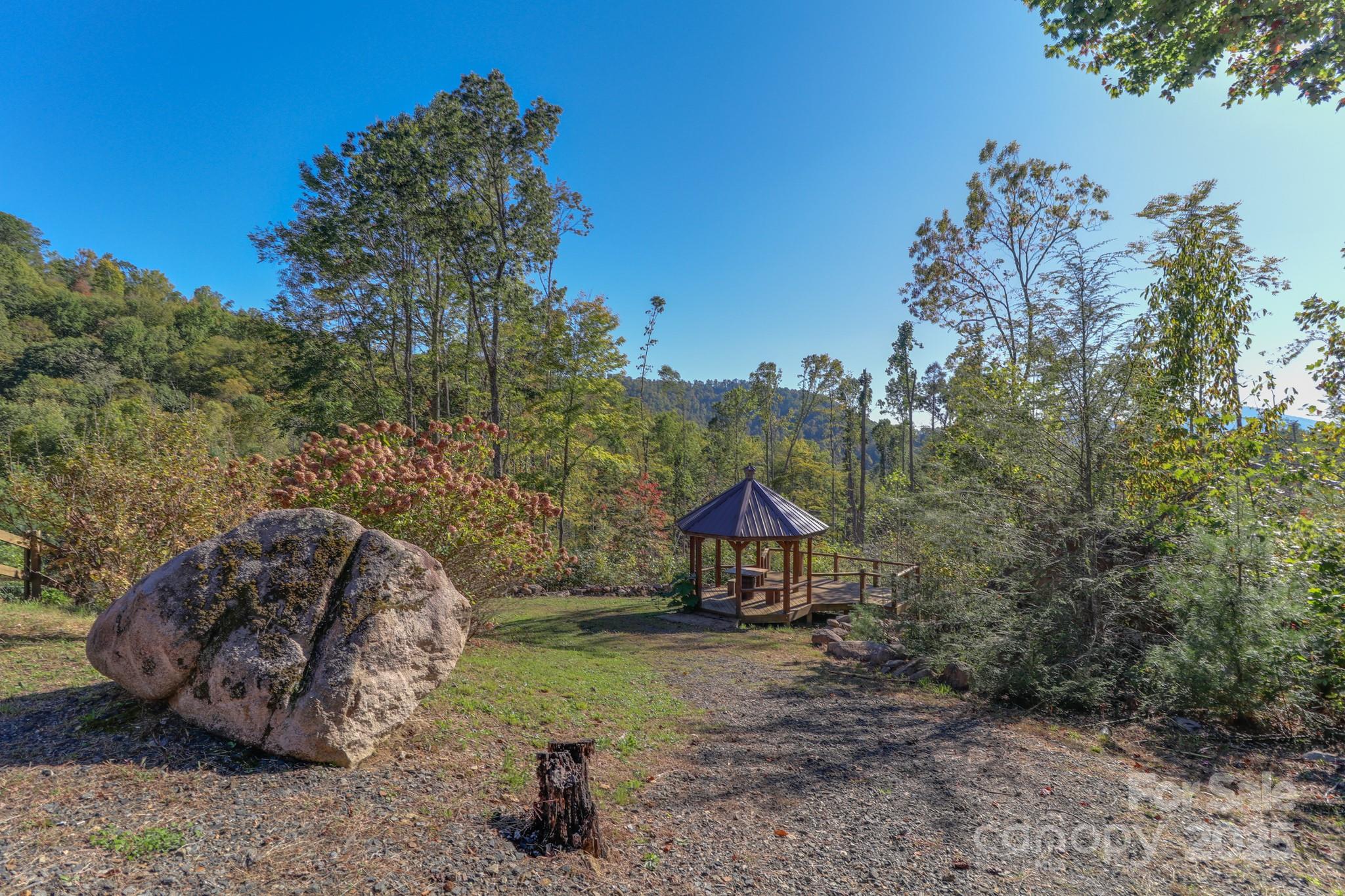 2811 Poplar Creek Road Green Mountain, NC 28740 - Photo 27 of 35 a view of a house with a yard and sitting area