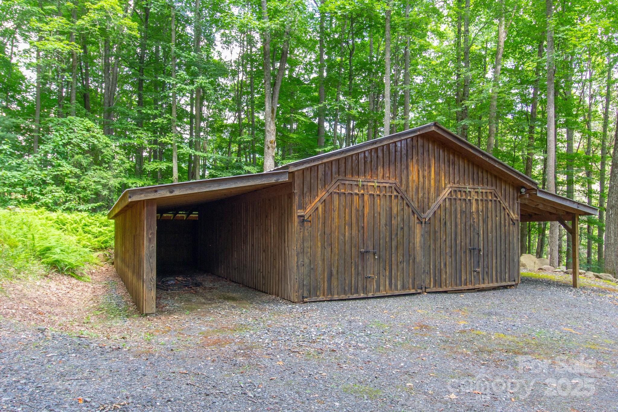 2811 Poplar Creek Road Green Mountain, NC 28740 - Photo 31 of 35 a backyard of a house with large trees and wooden fence