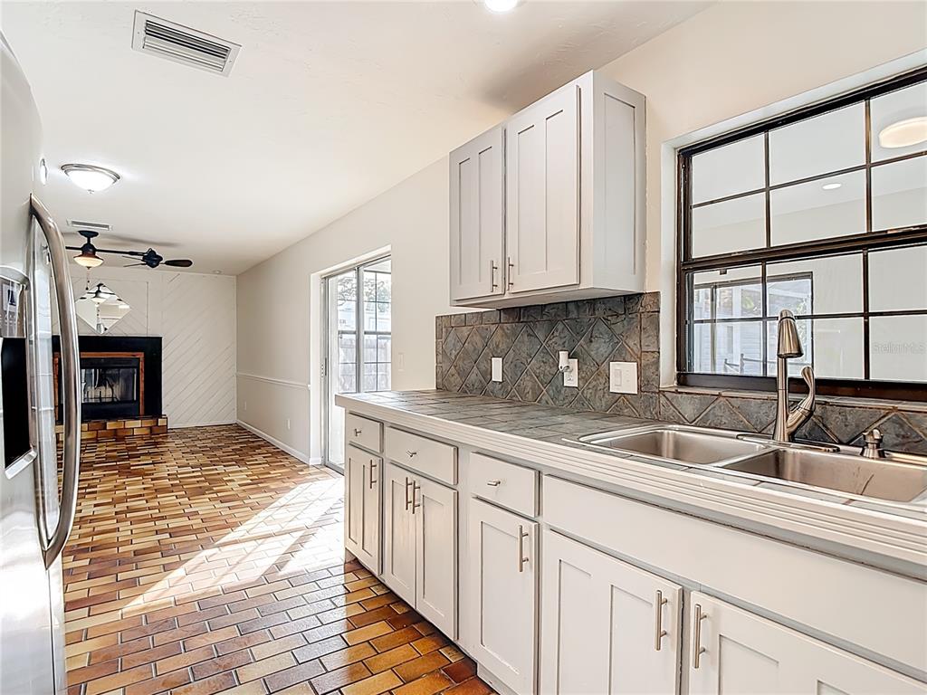 7286 Jonas Road Fort Myers, FL 33967 - Photo 18 of 81 a kitchen with stainless steel appliances granite countertop a sink and a white cabinets