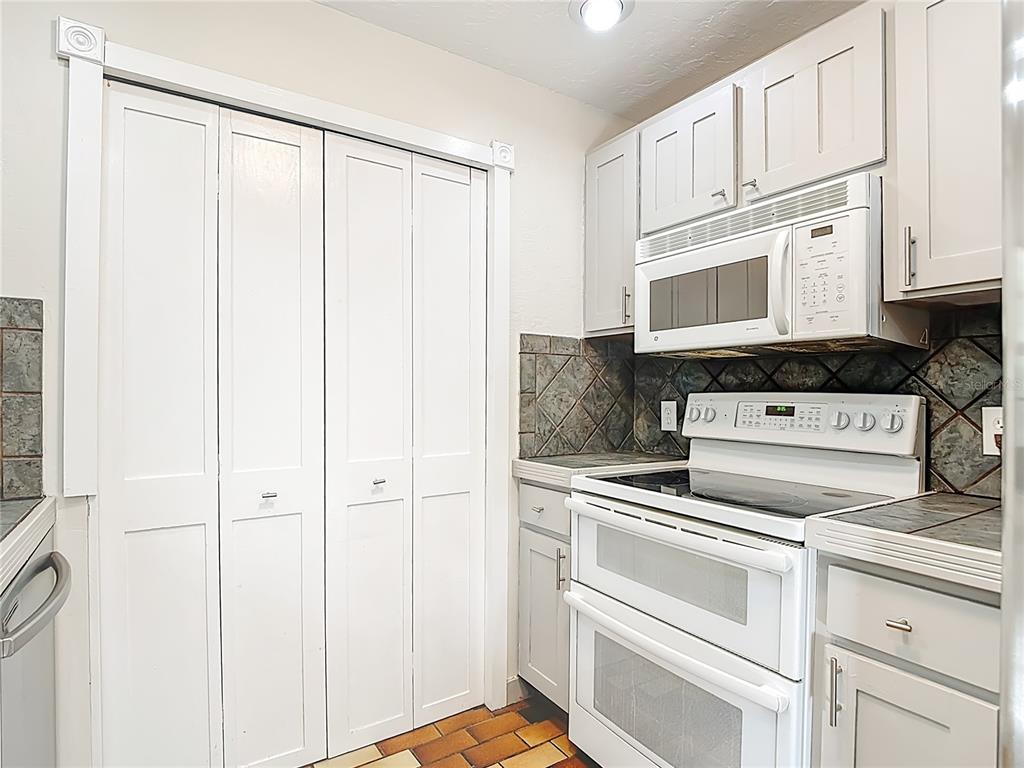 7286 Jonas Road Fort Myers, FL 33967 - Photo 23 of 81 a kitchen with white cabinets and white appliances