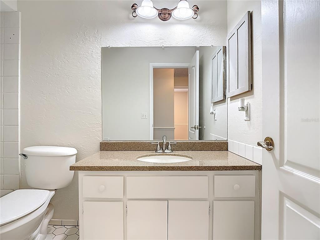 7286 Jonas Road Fort Myers, FL 33967 - Photo 34 of 81 a bathroom with a granite countertop sink toilet and mirror