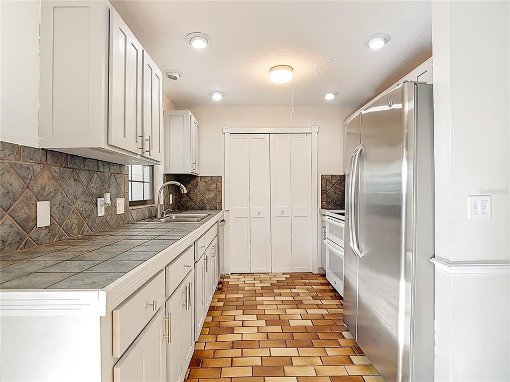 7286 Jonas Road Fort Myers, FL 33967 - Photo 4 of 81 a kitchen with kitchen island granite countertop a refrigerator and a sink