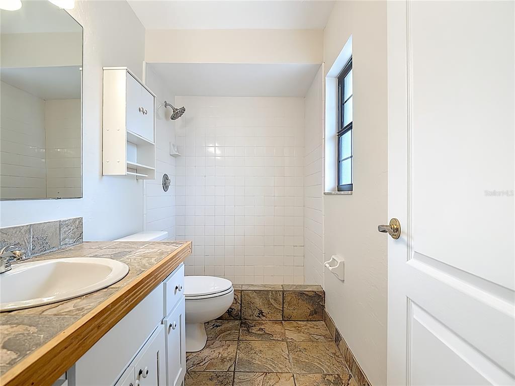 7286 Jonas Road Fort Myers, FL 33967 - Photo 42 of 81 a bathroom with a granite countertop sink toilet and shower