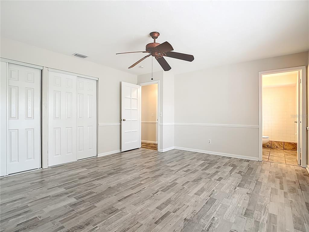 7286 Jonas Road Fort Myers, FL 33967 - Photo 44 of 81 a view of empty room with wooden floor and fan